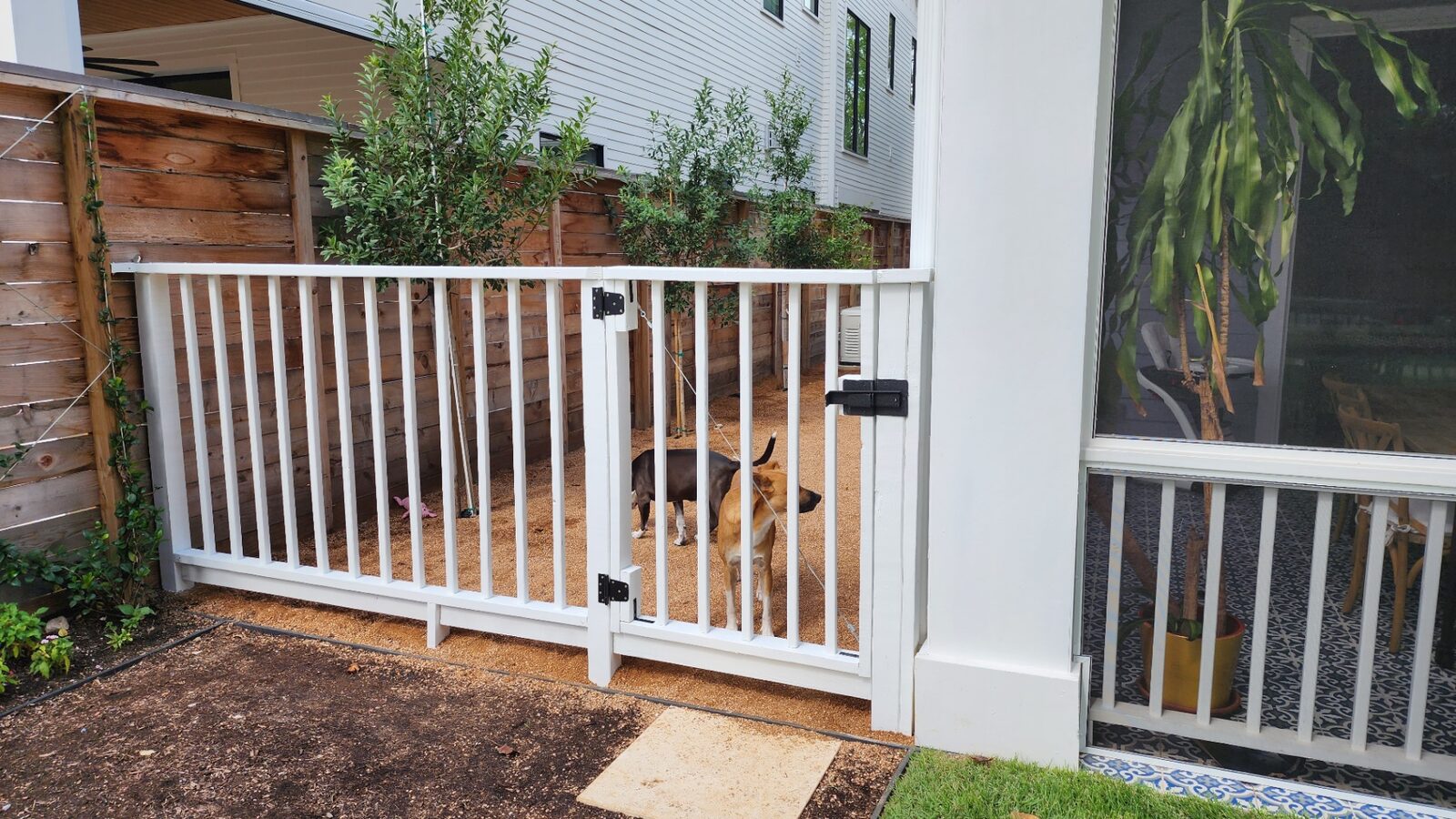 Crisp white painted railing and gate on a Houston property